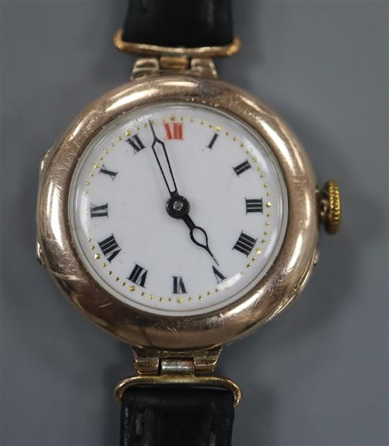 A ladys early 20th century 9ct gold manual wind wrist watch, on associated black leather strap.